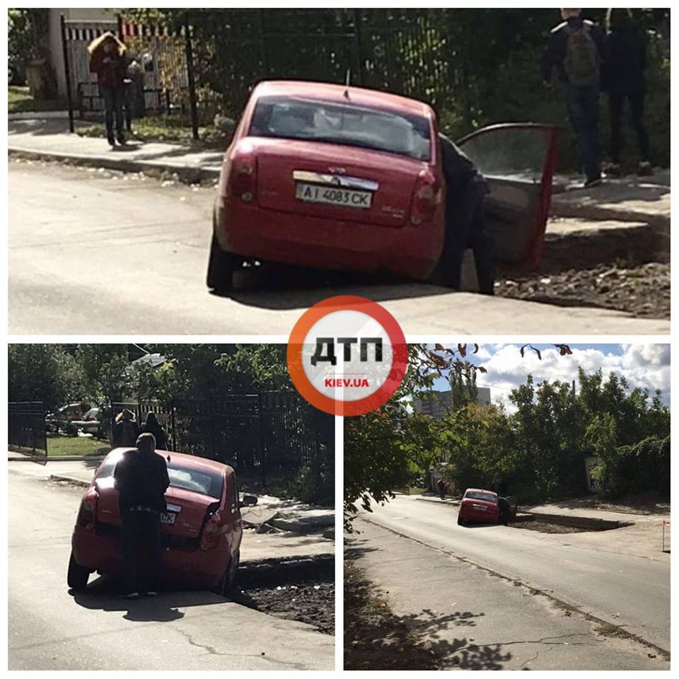"Крізь землю": у Києві авто провалилося у величезну яму (фото)